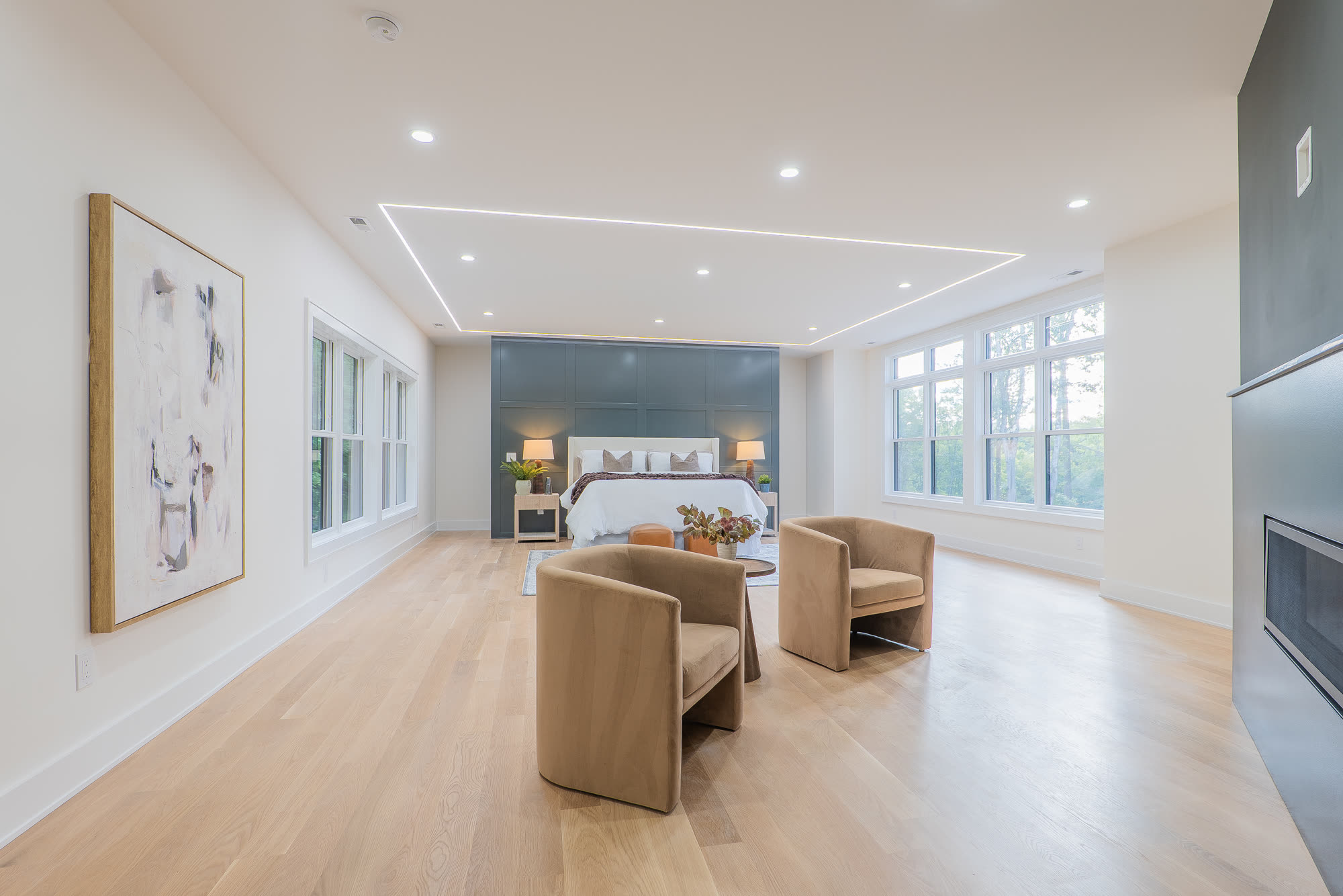 Primary suite with sitting area and fireplace wall