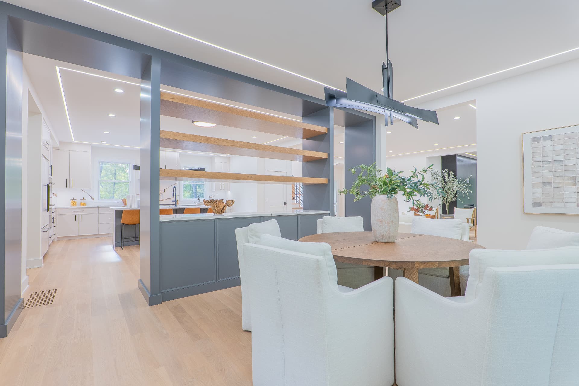 Dining room with custom millwork opening into the kitchen