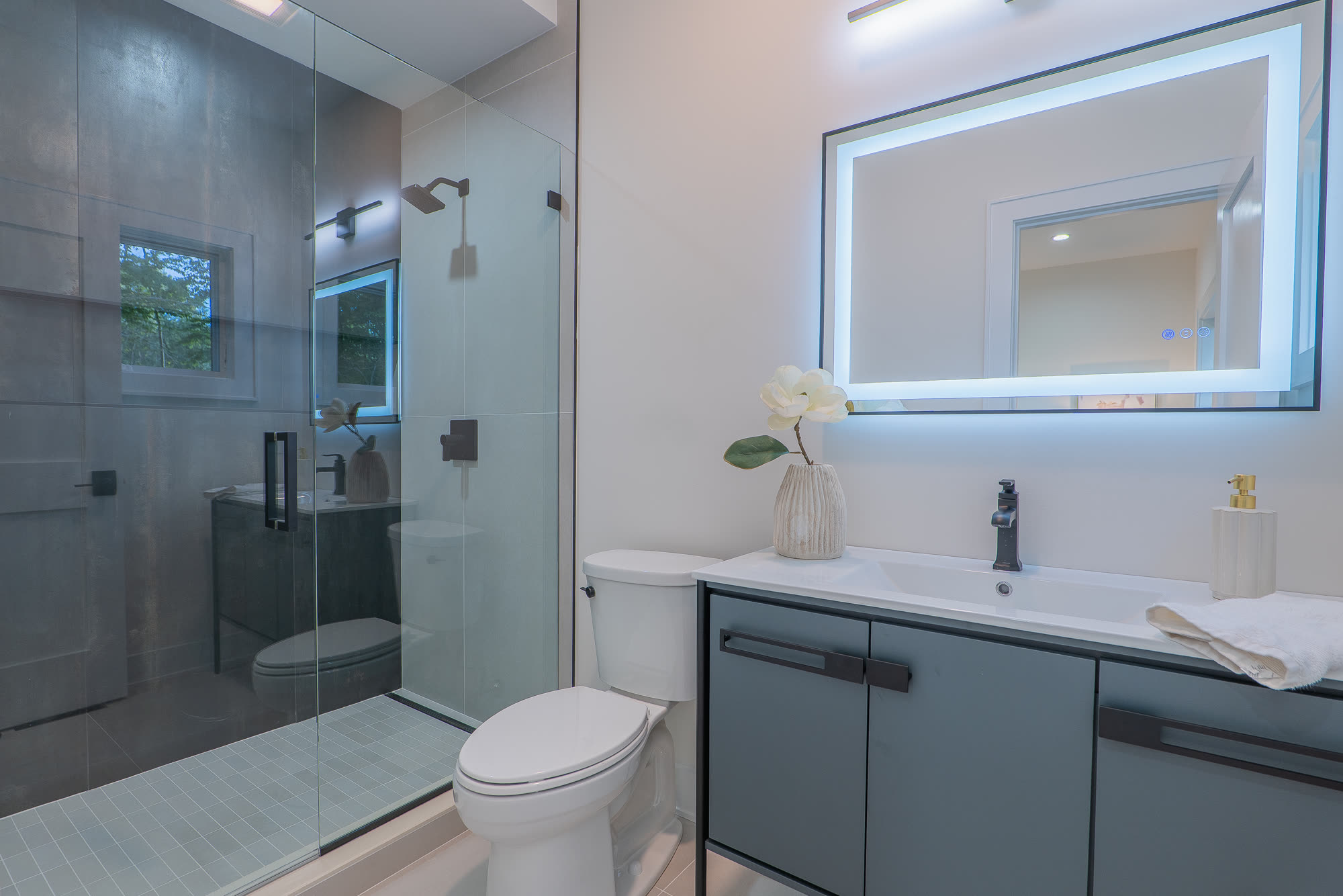 Bath with glass shower and floating vanity
