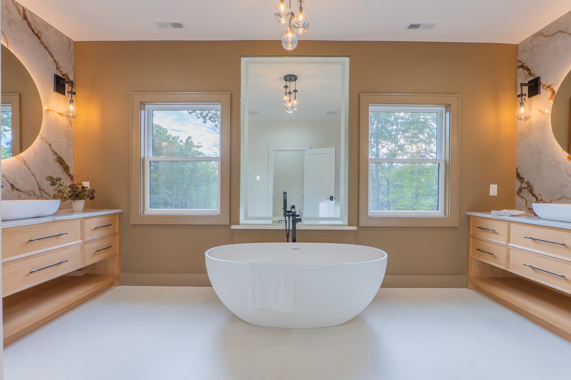 Primary bath with freestanding soaking tub and dual vanities
