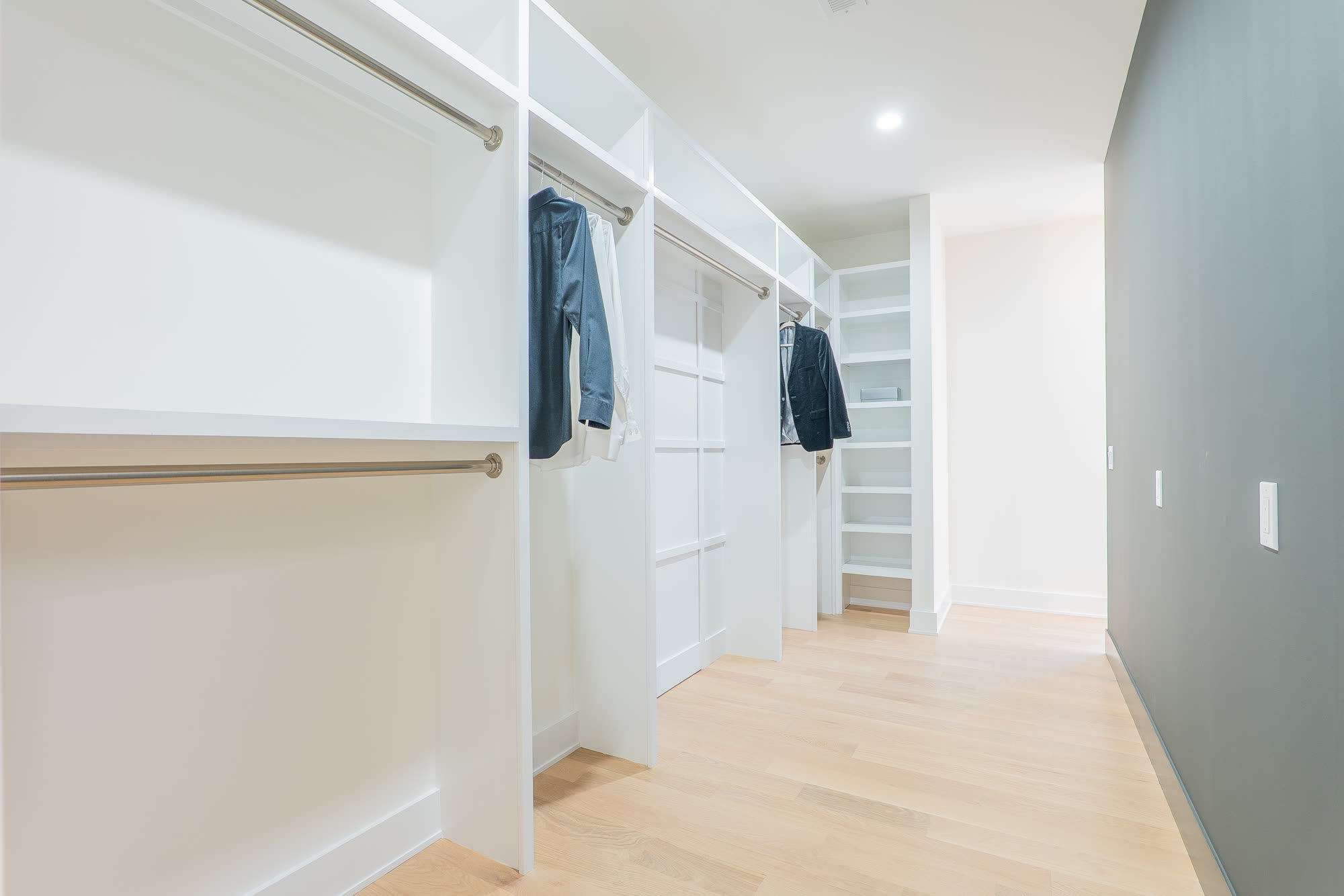 Second walk-in closet with hanging and drawer storage