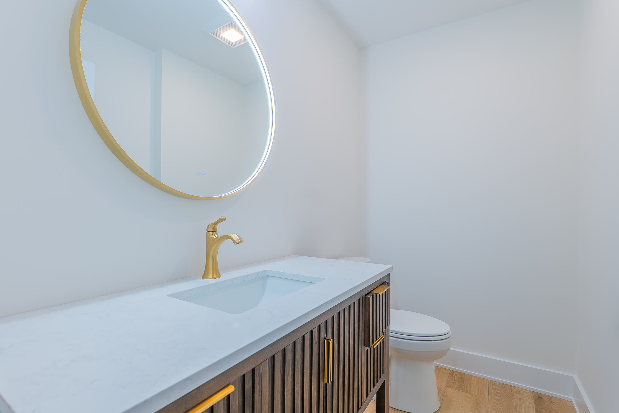 Second powder room with round lit mirror