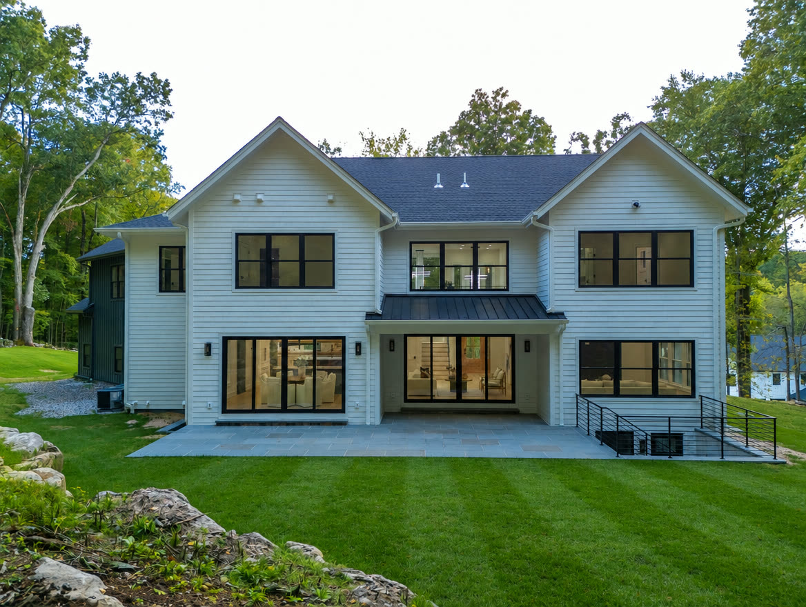 Rear exterior with covered patio and level lawn