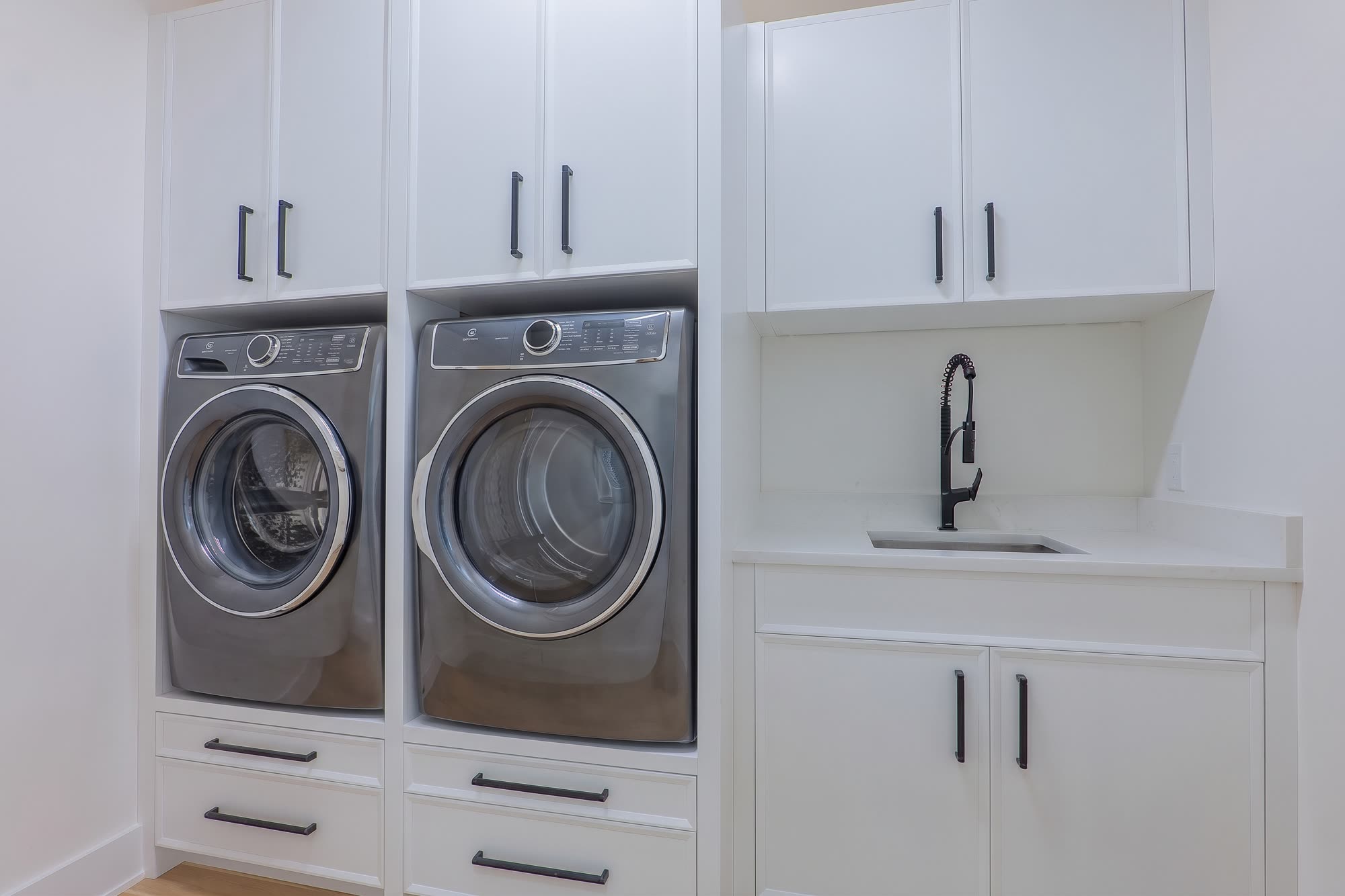 Laundry room with side-by-side washer, dryer and sink