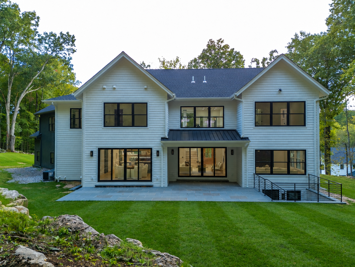 Rear exterior of 108 Old Farm Rd with bluestone patio, balcony railing and lawn